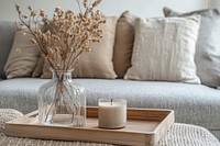 A wooden tray on the coffee table pillows minimalist flowers.