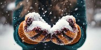 Wool gloves holding snow holding snow.