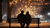 Couple sitting in bench romantic outdoors winter.