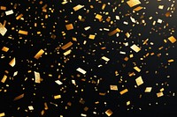 A black background with golden confetti falling all over it celebration atmosphere festive.