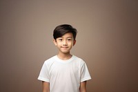 A young asian boy wearing a white T-shirt background portrait t-shirt.