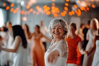 A smiling senior woman dancing at the gym happy adult face.