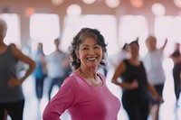 A smiling senior asian woman dancing at the gym lifestyle active happy.