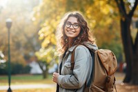 Smiling young woman student wearing glasses and casual backpack background happy.