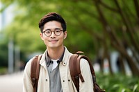 Smiling young asian man student wearing glasses and casual backpack background smile.