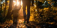 Parent and son holding hands sunlight walking photo.