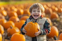 Child holding pumpkins boy outdoor smiling.