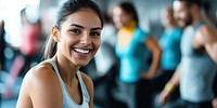 Woman doing a workout in a gym smiling person group.