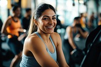 Woman doing a workout in a gym equipment smiling person.