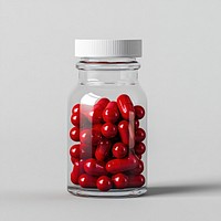 An isolated transparent bottle full of red capsule vitamin capsules jar pharmaceutical.