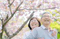 Japanese couple happy outdoors blossoms.