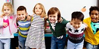 Group of diverse children smiling in classroom. Happy diverse children, boys and girls. Diverse children in classroom. Smiling children having fun together in classroom. Students have fun in classroom