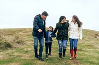 Happy Caucasian family holding hands outdoors, mother, father, son, and daughter. Family holding hands enjoying nature. Family trip outdoor nature. Family hold hands at coast nature outdoor.