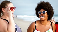 Diverse confident plus size women at the beach. Happy curvy women at the beach. Female friends spending quality time at the beach. Diverse friends travel to the beach.