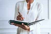 Professional woman writing notes image