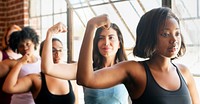 Diverse group of sportswomen flexing arms in a gym. Women in workout attire training in a gym. Sportswomen exercise at fitness. Strength and diversity in a gym setting. Health and wellness routine.