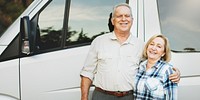 Happy senior couple standing by a van. Senior couple enjoying a trip with their van. Couple posing by their van, with happiness and adventure. Senior couple enjoying outdoors adventure and road trip.