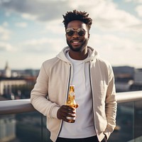 Young stylish black man sunglasses beer standing. 