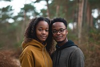 Black couple portrait standing forest.