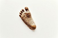 The brown foot imprint of a baby on a white background clothing apparel glove.