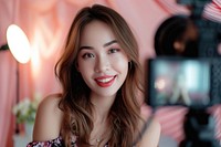 A asian girl take a selfie with video recording in front portrait smile photo.