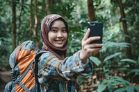 Backpacker Malaysian girl take a selfie nature photo photographing.