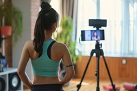A chinese girl with video recording in foreground tripod adult photo.