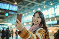 Asian influencer taking a selfie at the airport travel adult photographing.