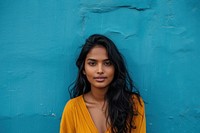 Indian american woman blue wall casual clothing.
