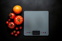 Weight scale with vegetable tomato plant food.