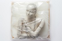 Plastic wrapping over a robot adult art white background.