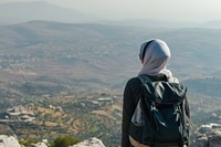 Middle eastern woman backpack backpacking landscape.