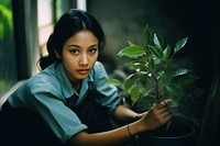 Young Thai women plant sitting green.