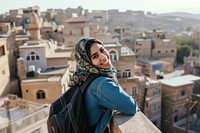 Happy Middle eastern girl traveler on the viewing town architecture cityscape.