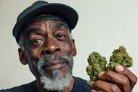 Black man holding cannabis buds portrait adult photo.