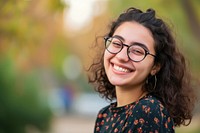 Middle-eastern college girl glasses laughing portrait.