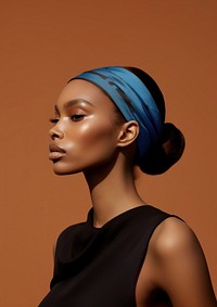 A black woman wearing blue eyeliner with modern brown 2023 headband photography portrait fashion.