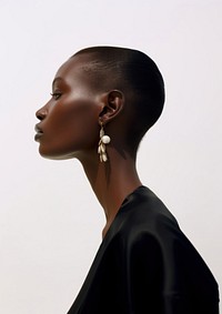 A black woman wearing modern minimal earring looking down the floor photography portrait jewelry.
