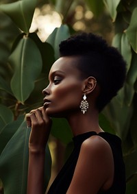 A black woman wearing modern diamond earring and ring photography portrait fashion.