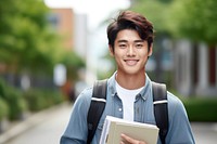 College student holding stack of books school smile happy. 