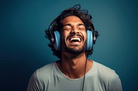 Indian man headphones shouting laughing.