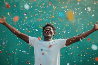 Cheerful black man with confetti enjoying cheerful celebration celebrating.