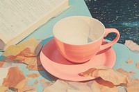 Coffee cup on a book saucer paper drink.