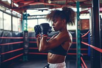 African American woman boxing sports gym.