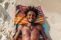 Ethiopian man sunbathing smile beach.