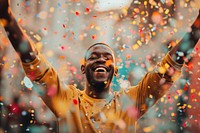 Cheerful black man with confetti enjoying cheerful adult celebration.