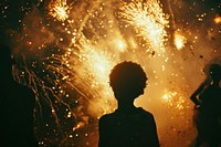 Fireworks with silhouettes of black people light adult backlighting.