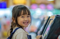 Little Japanese girl cashier child smile happy.