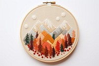 A piece of cute autumn Mountains in embroidery style mountain pattern representation.