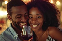 Happy black man couple celebrating embracing laughing drinking.